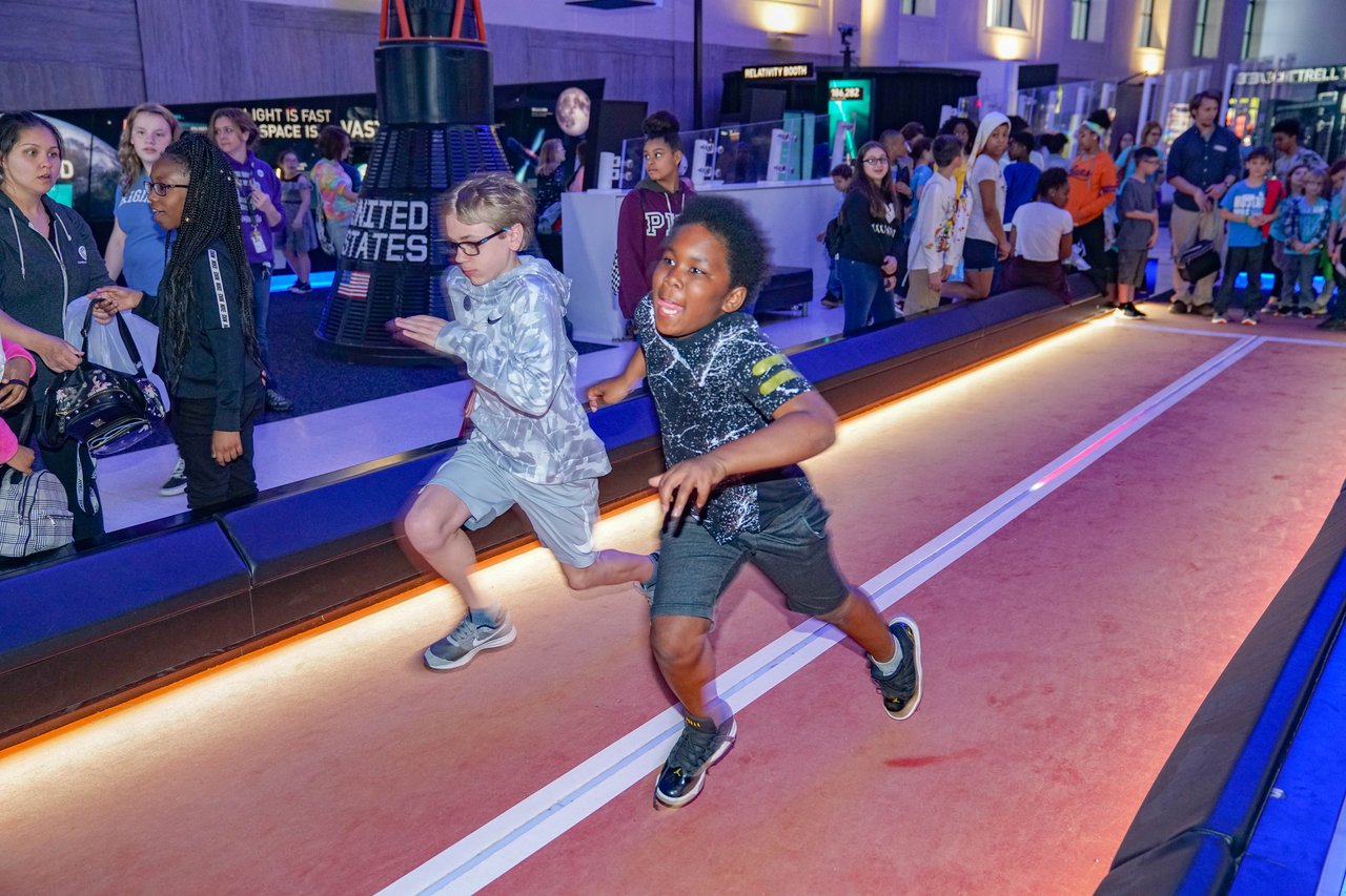 Children racing in Speed with an audience watching them.